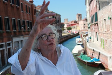 Venice Syndrome - Tudi Sammartini lives in one of the few neighbourhoods that resembles old Venice. She is descended from Venetian nobility, but doesn't live that way. She even waived her inheritance relating to the Palazzo on the Canale Grande. Tudy even rents out space to tourists in her apartment to afford to continue living their herself. Photo Credit: Venedig-Prinzip/vkpr