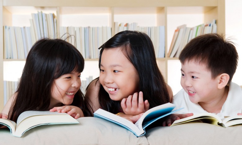 three kids reading books